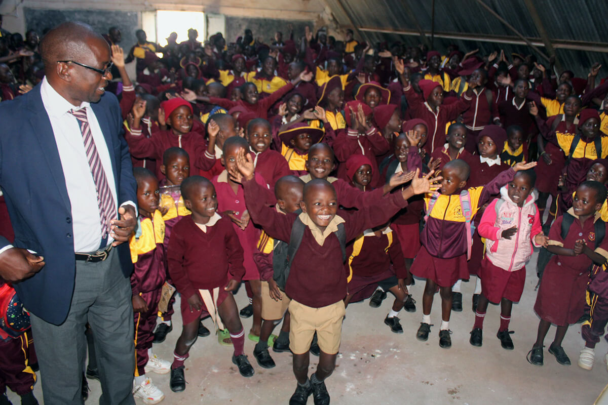 Students dance with joy after a worship service at Dindi Mission’s primary school in Mutawatawa, Zimbabwe. At left is Fungai Chimuti, the school’s headmaster. A new boarding facility for the mission’s schools is helping address high dropout rates and other challenges. Photo by Kudzai Chingwe, UM News. 