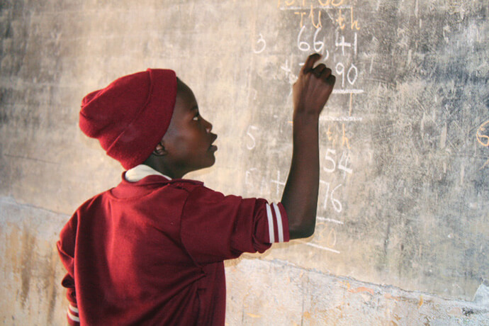 Clint Chidabvu, a Grade 4 student, works on math problems at United Methodist Dindi Mission in Zimbabwe. Photo by Kudzai Chingwe, UM News.